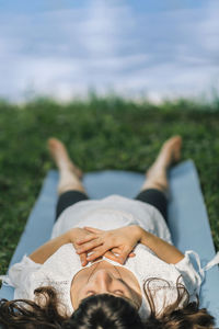 Meditating by the water. young woman lying by the water and meditating