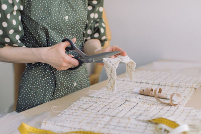 Midsection of woman working on table