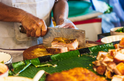 Midsection of man preparing food