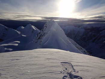 Scenic view of snow covered mountains against sky