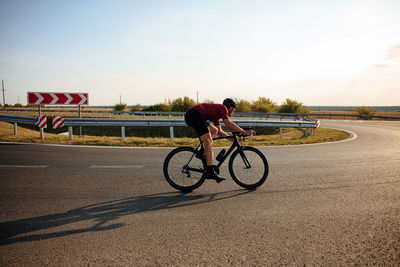 Man riding bicycle on road