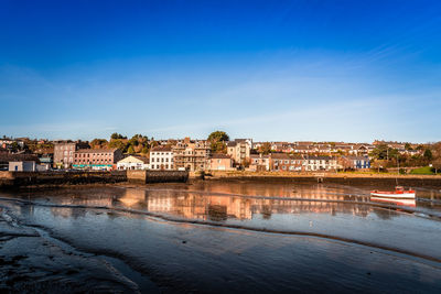 Buildings by river in city