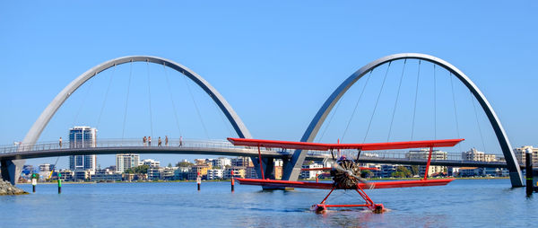 People on boat against clear blue sky