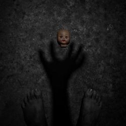 High angle portrait of boy standing against wall
