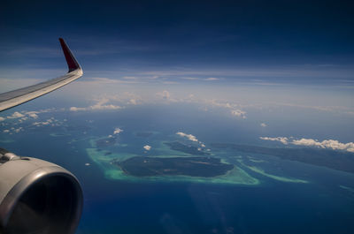 Cropped image of airplane over landscape