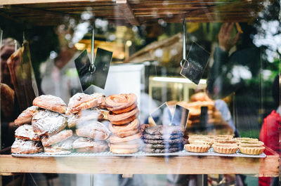 Bread seen through glass at market stall for sale