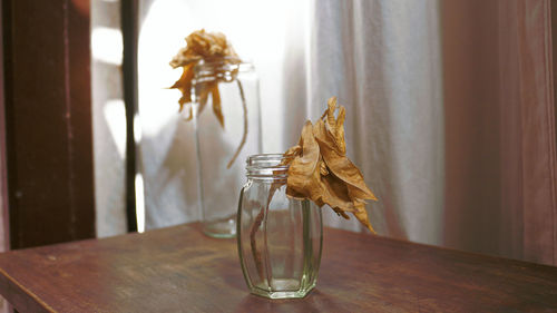 Close-up of glass vase on table at home