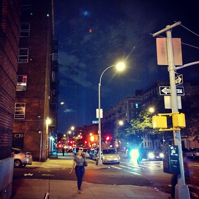 VIEW OF ILLUMINATED STREET AT NIGHT