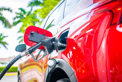 Close-up of red vintage car on side-view mirror