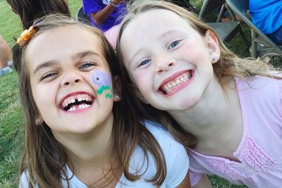 High angle portrait of happy siblings at park