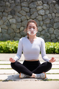 Beautiful chinese girl wearing n95 face mask while working out