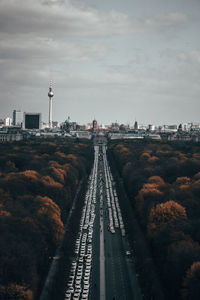 High angle view of road by city against sky