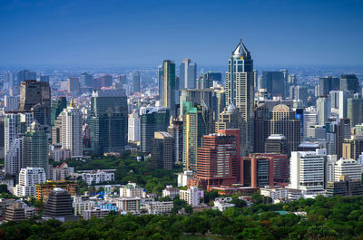 The business landscape modern buildings around the park in downtown bangkok, thailand.