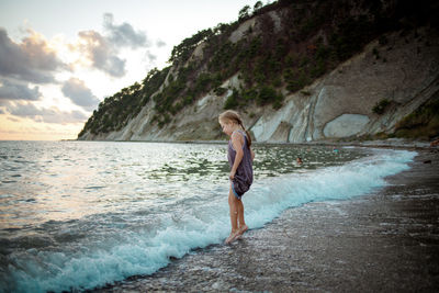 Full length of woman on beach against sky