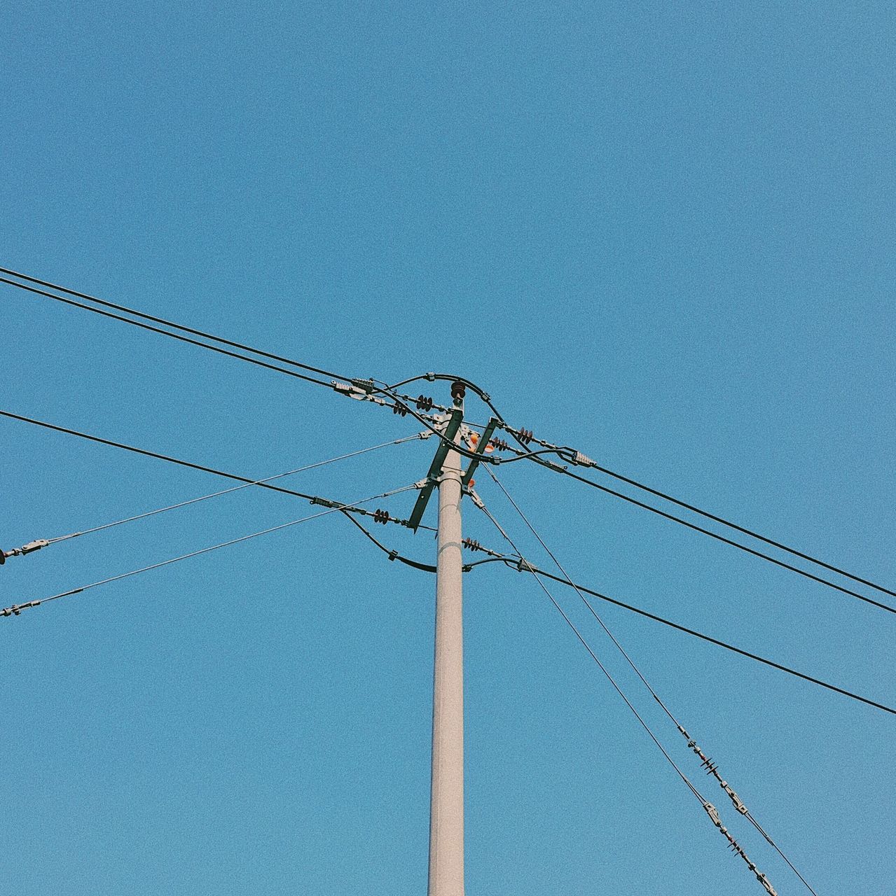 cable, low angle view, connection, electricity, power supply, blue, power line, copy space, clear sky, day, technology, fuel and power generation, electricity pylon, no people, outdoors, telephone line