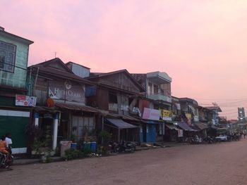 Residential buildings against sky during sunset