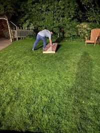 Woman sitting on grass in lawn