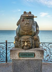 Sculpture by sea against sky