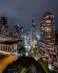 High angle view of illuminated buildings against sky at night