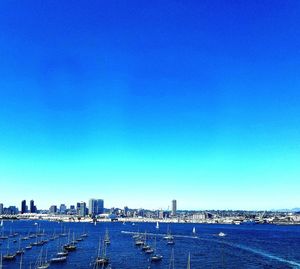 View of buildings against clear blue sky