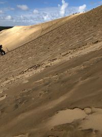 Sand dunes in desert against sky