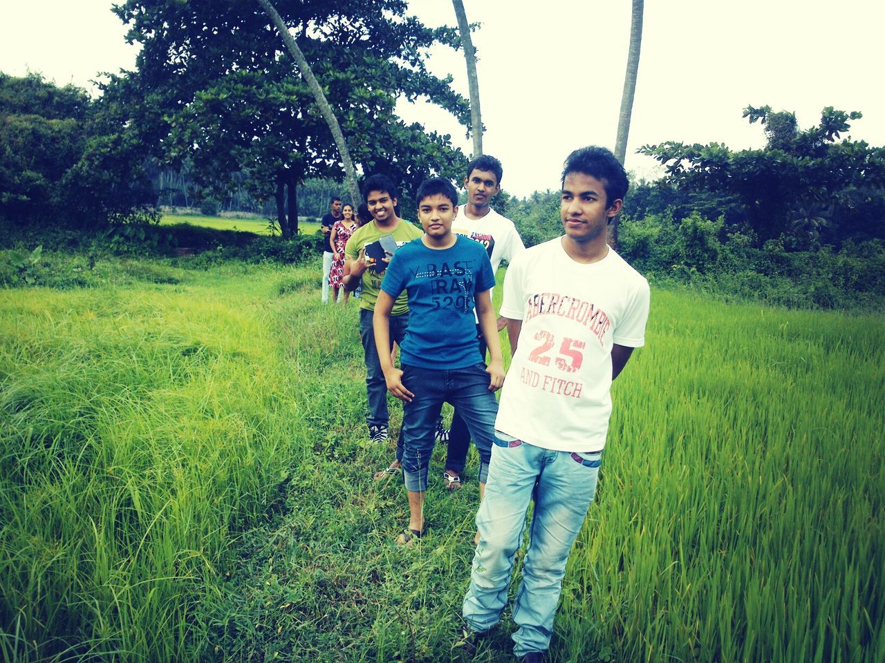 lifestyles, person, casual clothing, leisure activity, grass, full length, young men, front view, smiling, happiness, field, standing, young adult, boys, childhood, looking at camera, portrait, elementary age