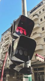 Low angle view of road sign against buildings in city