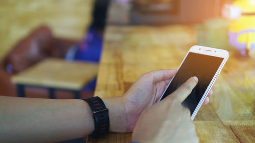 Midsection of man using mobile phone