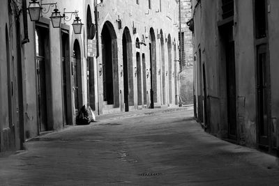 Empty alley amidst buildings in city