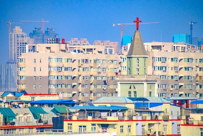 Multi colored buildings against blue sky