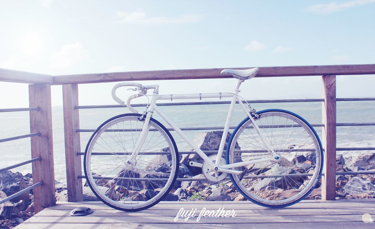 bicycle, transportation, mode of transport, land vehicle, stationary, parking, parked, sky, water, day, railing, wheel, no people, outdoors, cycle, tranquility, cloud - sky, nature, sea, sunlight