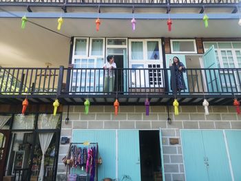 Low angle view of people standing against building