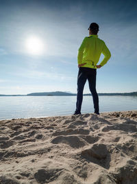 Morning workout. warming up before training. sportsman in sportswear doing stretching on the beach 