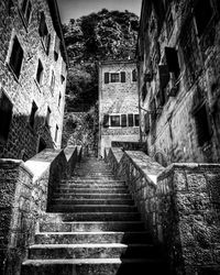Low angle view of staircase amidst buildings