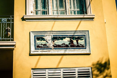 Low angle view of glass window on building