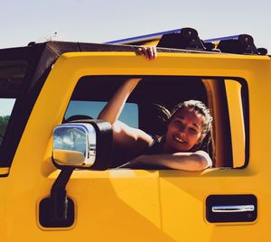 Portrait of smiling woman in car