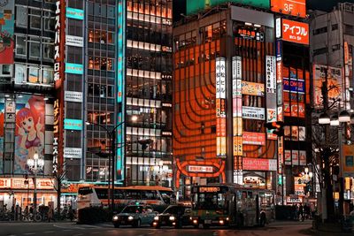 Illuminated city street and buildings at night