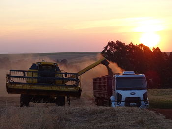 Scenic view of field against sky during sunset