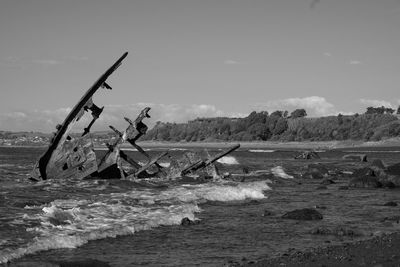 Fishing net in sea against sky