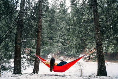 People on street amidst trees during winter