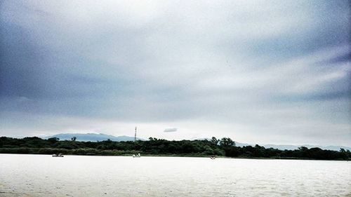 Scenic view of sea against cloudy sky