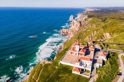 High angle view of sea and buildings against sky