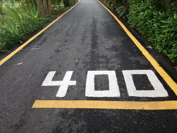 High angle view of arrow sign on road in city