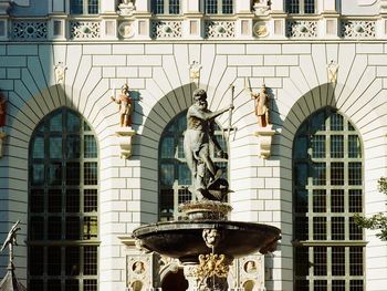 Low angle view of statue against historic building