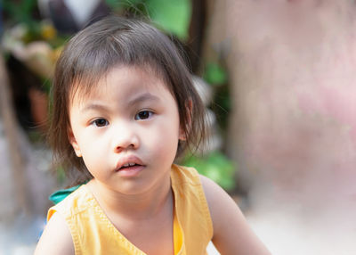 4 years old cute baby asian girl, little toddler child with adorable short hair looking to camera. 