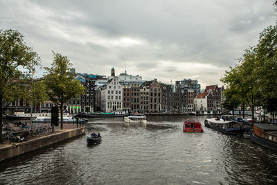 Boats in river in city