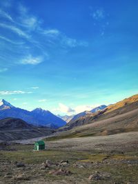 Scenic view of mountains against blue sky