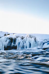 Scenic view of sea against clear sky during winter