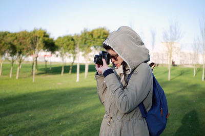 Man photographing on field