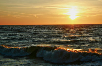 Scenic view of sea wave against sky during sunset